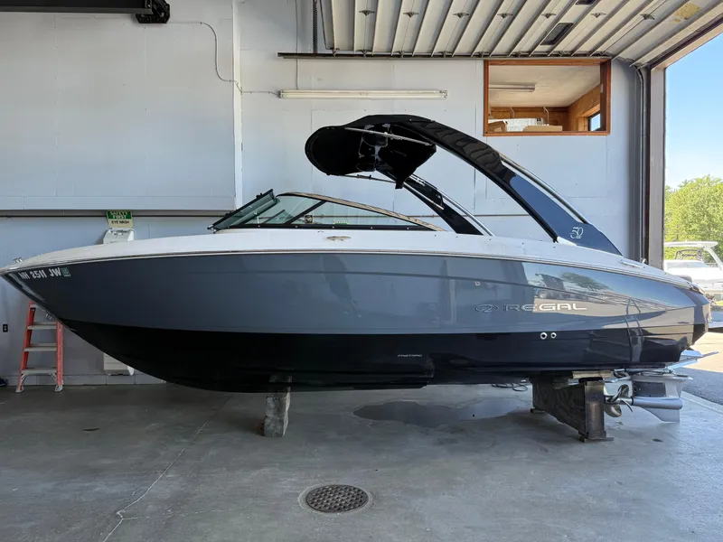 The Image of 2020 Regal LS4 Surf boat in a garage, side view. - 0