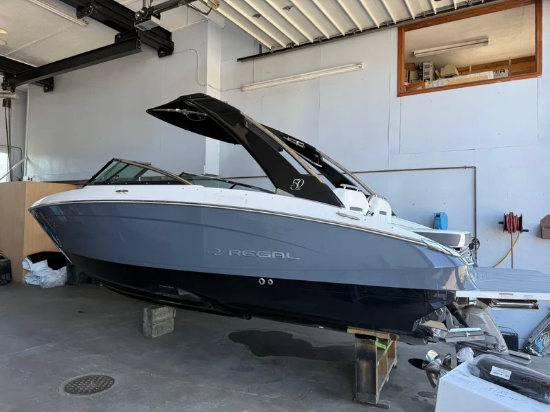 Slide: The Image of 2020 Regal LS4 Surf boat in a garage, showcasing sleek design and modern features. - 1