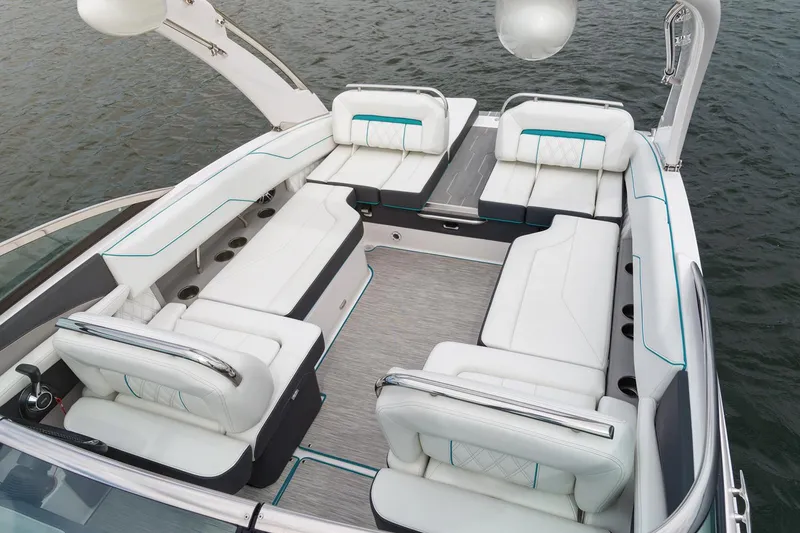 Slide: The Image of Manufacturer Provided Image: 2020 Regal LS4 Surf boat interior with white seating on the water. - 18