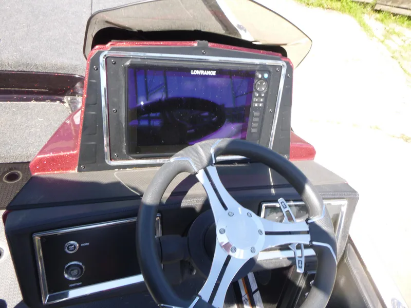 Slide: The Image of 2024 Ranger Z521R boat dashboard with steering wheel and Lowrance display. - 10