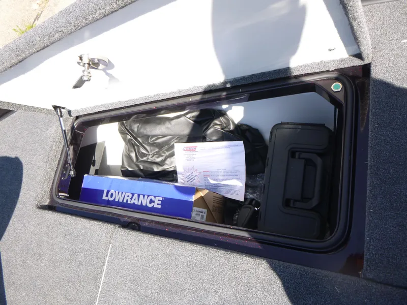 Slide: The Image of Open storage compartment in 2024 Ranger Z521R boat with Lowrance equipment. - 16