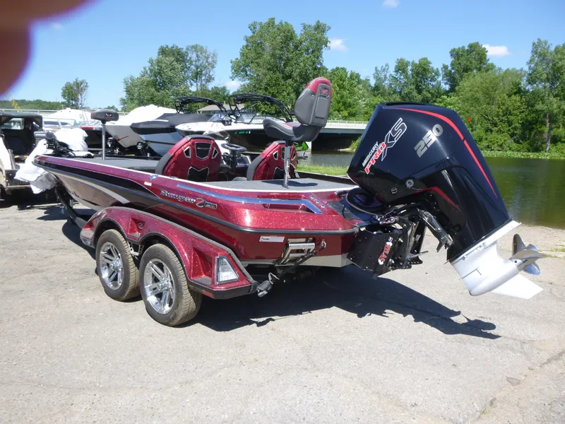 Slide: The Image of 2024 Ranger Z521R Ranger Cup Equipped boat with powerful engine, parked near a scenic river. - 4