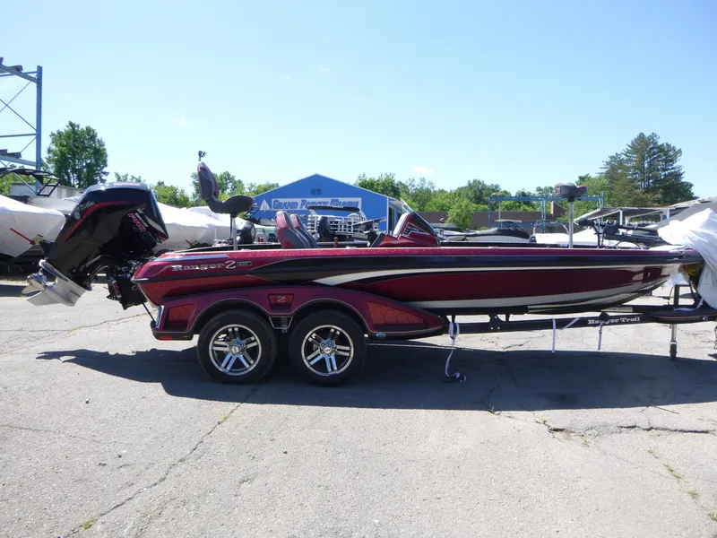 Slide: The Image of 2024 Ranger Z521R Ranger Cup Equipped boat, red, parked outdoors on a sunny day. - 6