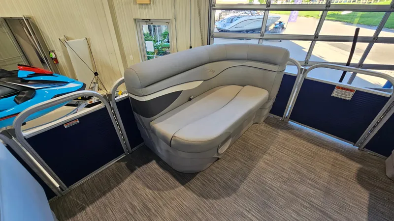 Slide: The Image of Interior of 2020 Bennington 188 SV pontoon boat with gray seating and blue accents. - 10