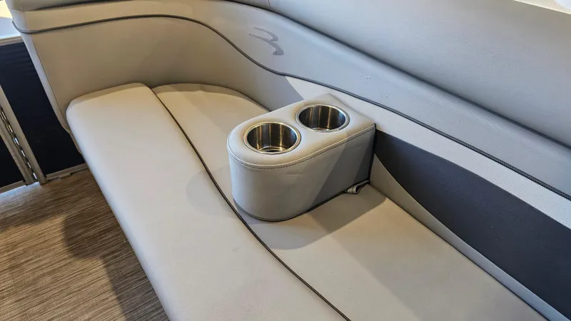 Slide: The Image of 2020 Bennington 188 SV boat interior with gray seating and dual cup holders. - 18