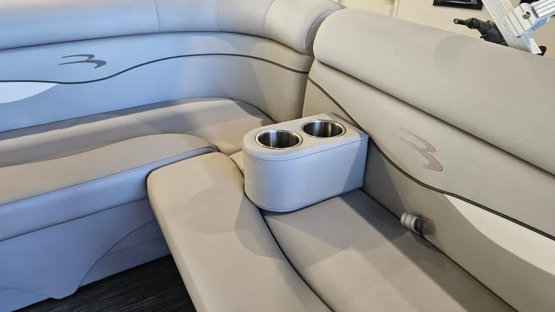Slide: The Image of 2020 Bennington 188 SV boat interior with beige seating and built-in cup holders. - 19