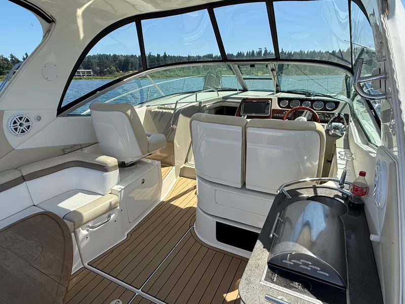 Slide: The Image of Interior of 2012 Sea Ray 370 Sundancer yacht with helm and seating area. - 10