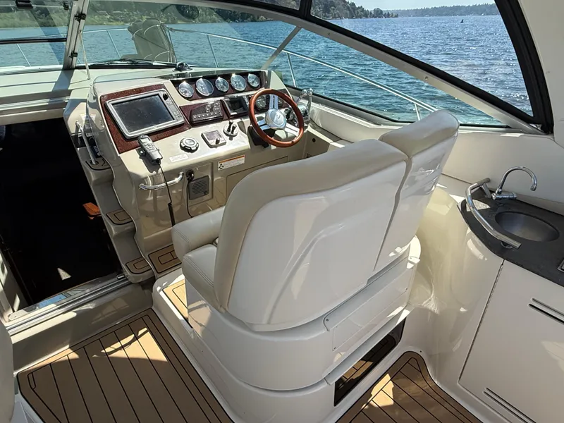 Slide: The Image of Interior of 2012 Sea Ray 370 Sundancer boat with helm, steering wheel, and sink. - 11