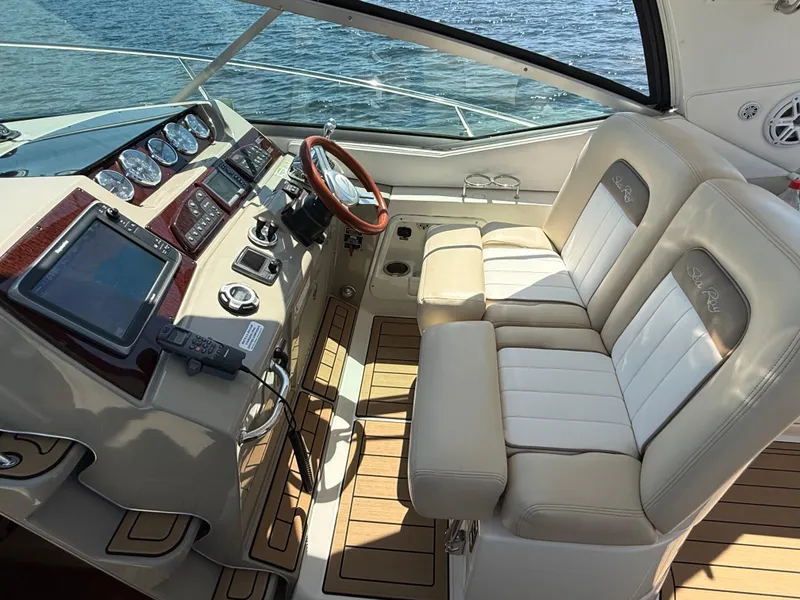 Slide: The Image of Helm of 2012 Sea Ray 370 Sundancer with dual seats and advanced navigation controls. - 12