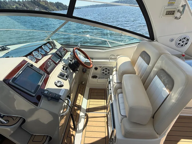 Slide: The Image of Interior of 2012 Sea Ray 370 Sundancer yacht with modern dashboard and leather seating. - 13