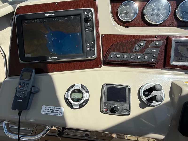 Slide: The Image of Control panel of a 2012 Sea Ray 370 Sundancer with navigation and communication equipment. - 15