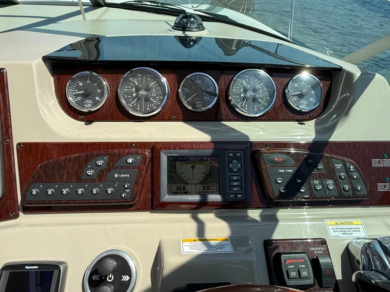 Slide: The Image of Dashboard of a 2012 Sea Ray 370 Sundancer boat with gauges and controls. - 17