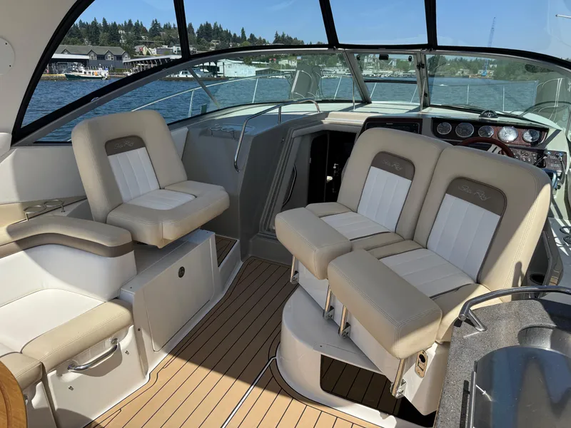 Slide: The Image of Interior of 2012 Sea Ray 370 Sundancer boat with beige seating and wood flooring. - 24