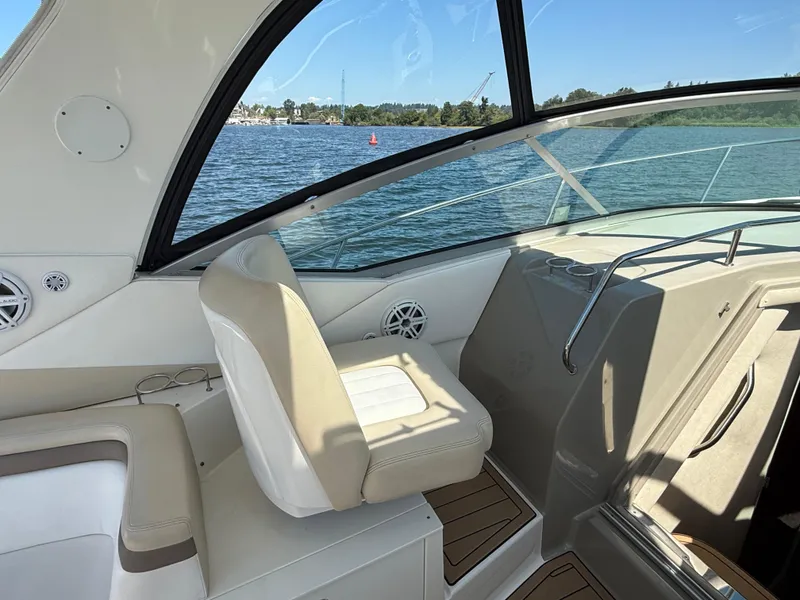 Slide: The Image of Interior view of 2012 Sea Ray 370 Sundancer boat with seating and water backdrop. - 28
