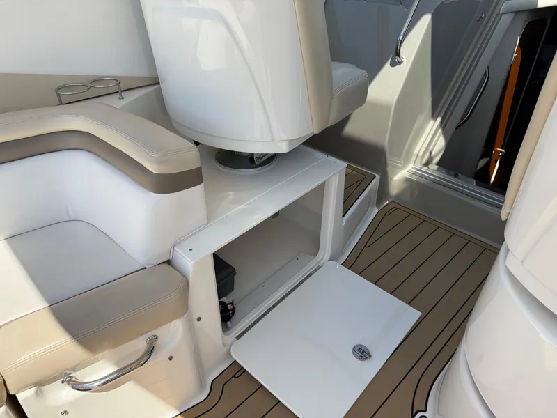 Slide: The Image of Interior of 2012 Sea Ray 370 Sundancer with open storage compartment and seating. - 32
