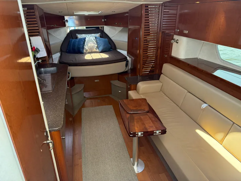 Slide: The Image of Luxurious interior of 2012 Sea Ray 370 Sundancer yacht with cozy seating and elegant wood finishes. - 37