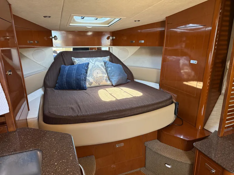 Slide: The Image of Luxurious cabin interior of 2012 Sea Ray 370 Sundancer yacht with cozy bed and pillows. - 38