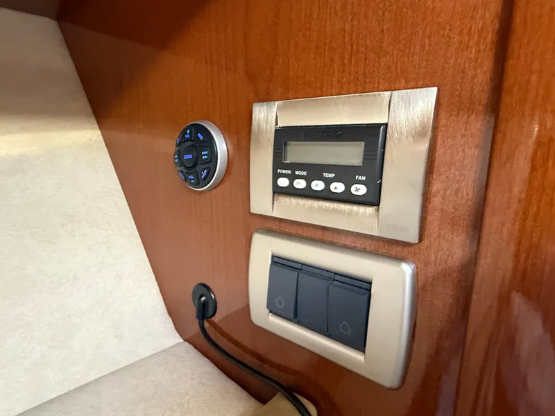 Slide: The Image of Control panel on 2012 Sea Ray 370 Sundancer boat, featuring temperature and fan settings. - 39