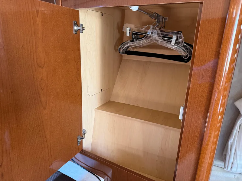 Slide: The Image of Wooden cabinet with hangers inside a 2012 Sea Ray 370 Sundancer yacht. - 41