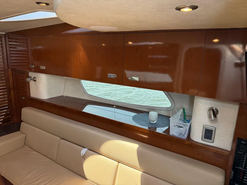 Slide: The Image of Luxurious interior of 2012 Sea Ray 370 Sundancer yacht with wooden cabinets and leather seating. - 45
