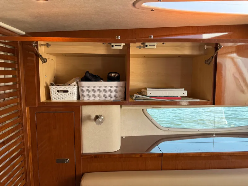 Slide: The Image of Interior storage of 2012 Sea Ray 370 Sundancer with wooden cabinets and organized baskets. - 47