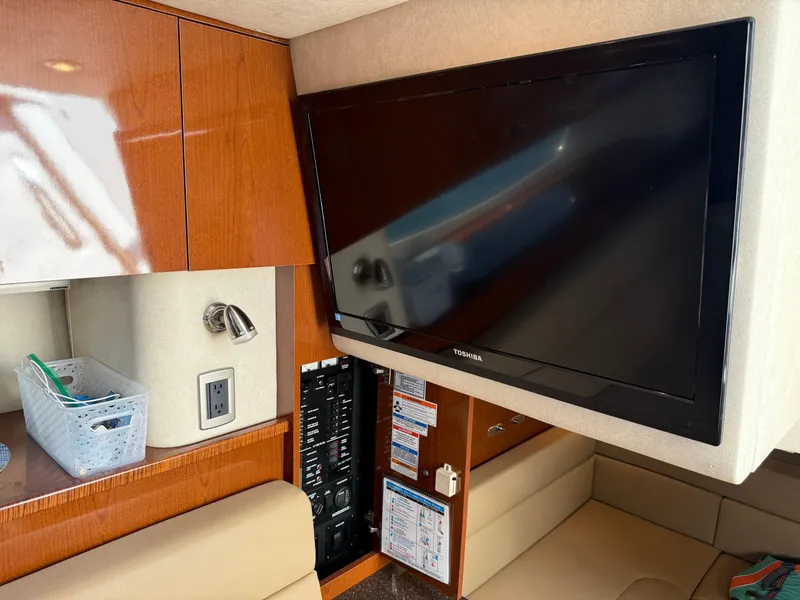 Slide: The Image of Interior of 2012 Sea Ray 370 Sundancer with TV and wooden cabinetry. - 49