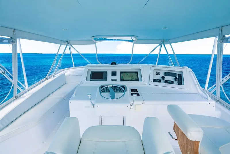 Slide: The Image of 1999 Viking Convertible yacht helm with ocean view, featuring modern navigation equipment. - 12