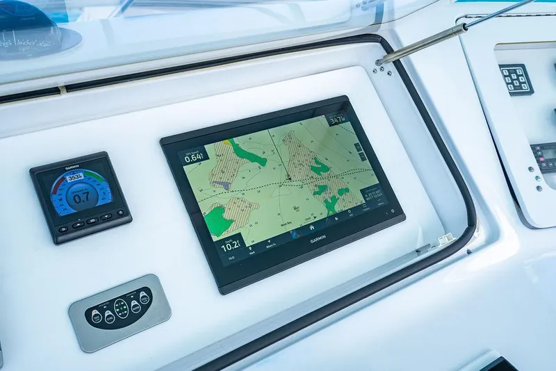 Slide: The Image of Navigation dashboard of a 1999 Viking Convertible boat with Garmin display. - 16