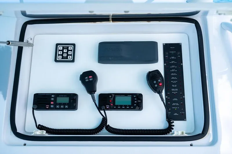 Slide: The Image of Control panel of a 1999 Viking Convertible boat with communication devices and keypad. - 18