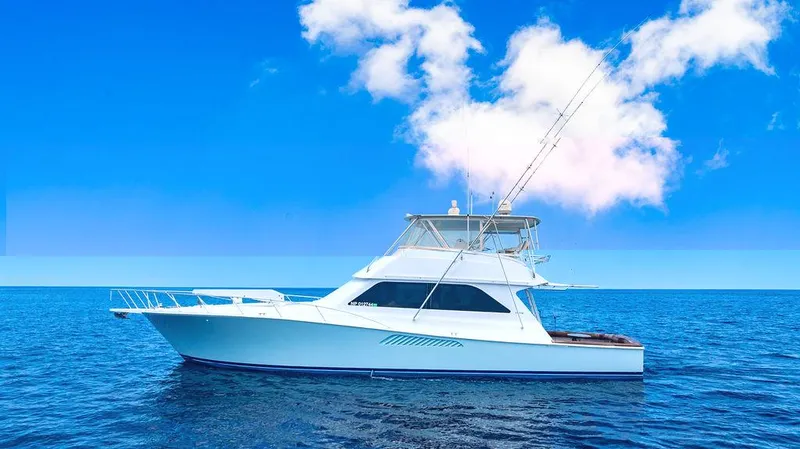 Slide: The Image of 1999 Viking Convertible yacht on open sea under clear blue sky. - 2