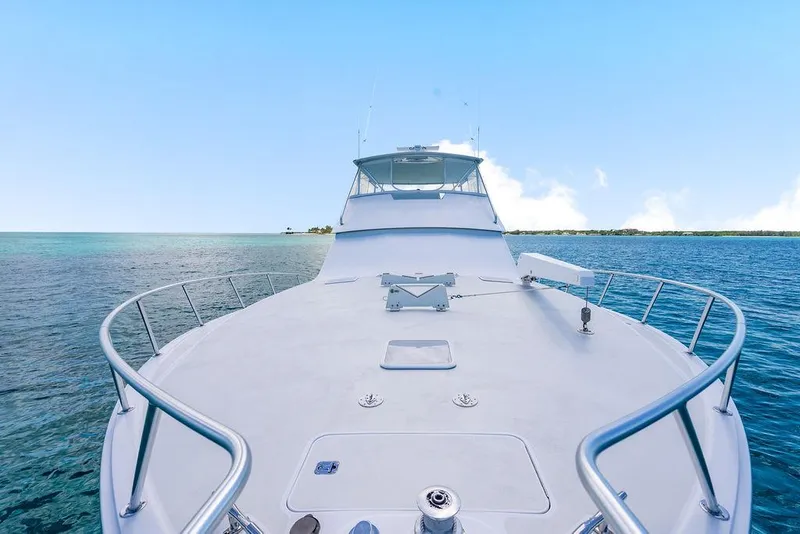 Slide: The Image of 1999 Viking Convertible yacht cruising on clear blue ocean waters. - 24