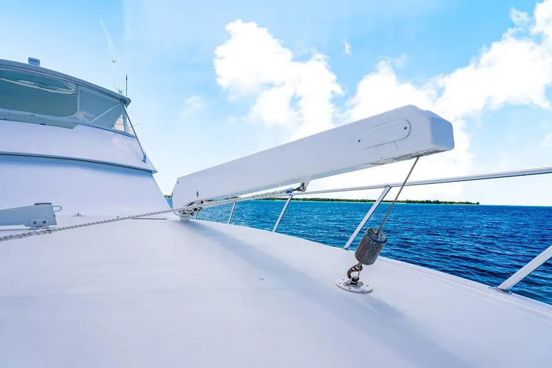 Slide: The Image of 1999 Viking Convertible yacht deck with ocean view under clear blue sky. - 26