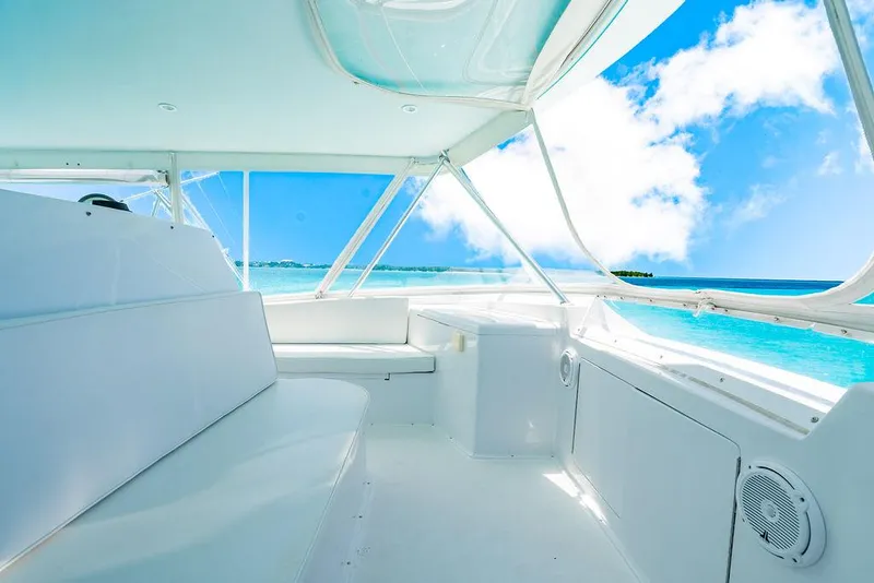 Slide: The Image of Interior of a 1999 Viking Convertible yacht with ocean view and white seating. - 29