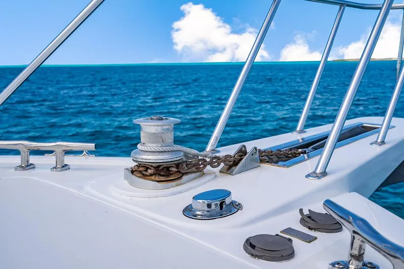 Slide: The Image of Bow of a 1999 Viking Convertible yacht with ocean view and anchor chain. - 32