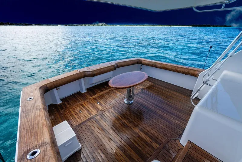 Slide: The Image of 1999 Viking Convertible yacht deck with wooden flooring and ocean view. - 36