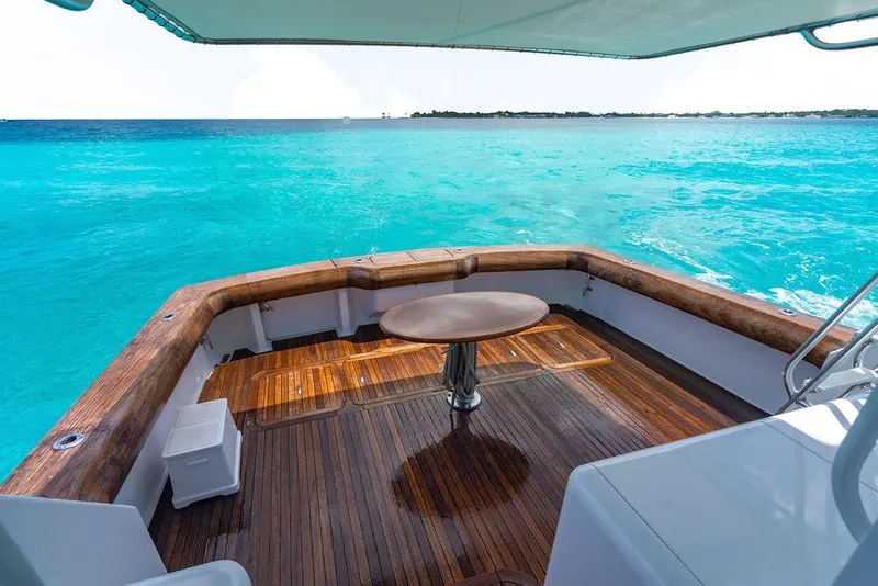 Slide: The Image of 1999 Viking Convertible yacht deck overlooking turquoise ocean waters. - 37