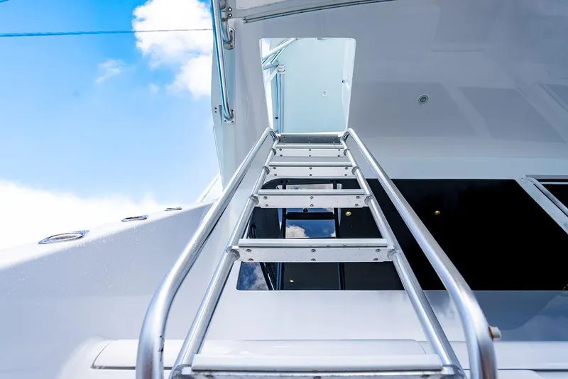 Slide: The Image of Ladder on 1999 Viking Convertible yacht against blue sky background. - 39