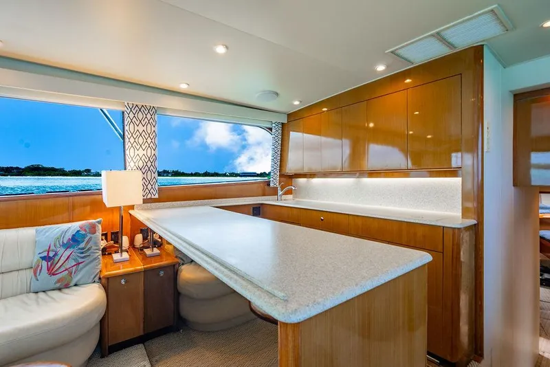 Slide: The Image of Luxurious interior of a 1999 Viking Convertible yacht with modern kitchen and scenic window view. - 41