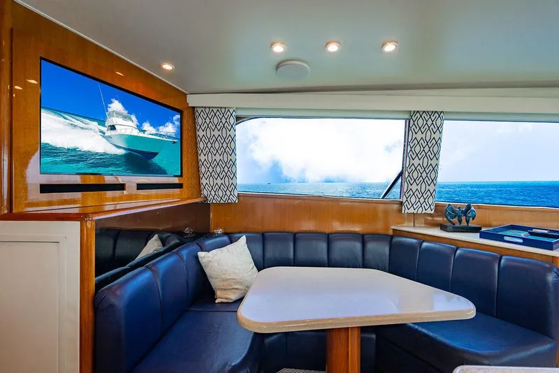 Slide: The Image of Luxurious interior of a 1999 Viking Convertible yacht with ocean view and plush seating. - 47