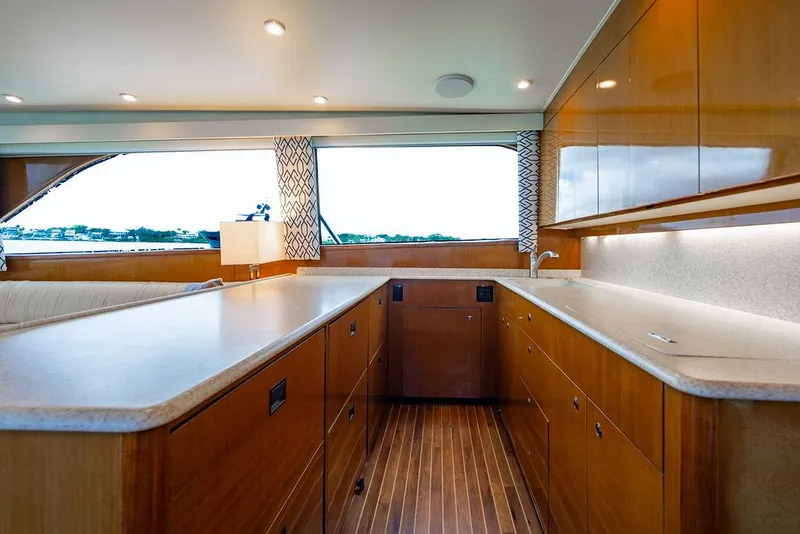 Slide: The Image of Interior of a 1999 Viking Convertible yacht with modern kitchen and wooden cabinetry. - 48