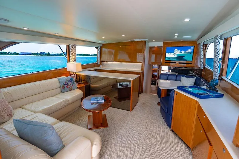 Slide: The Image of Luxurious interior of a 1999 Viking Convertible yacht with elegant furnishings and scenic ocean view. - 49