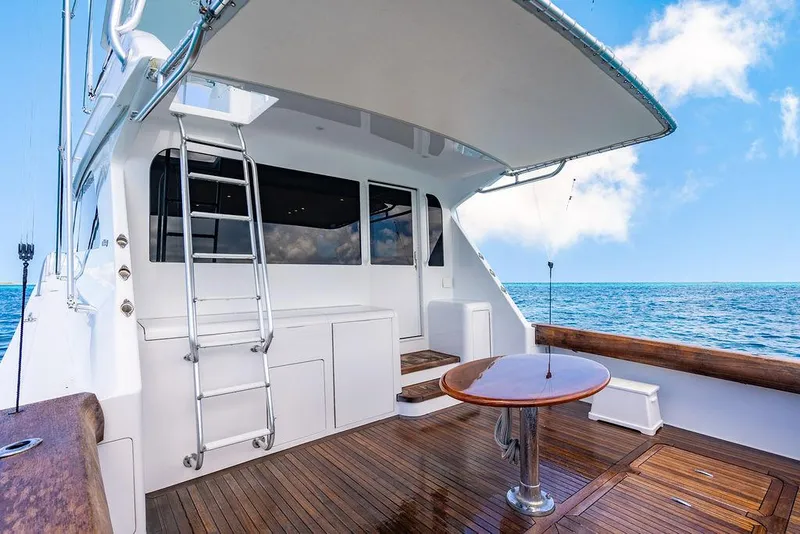 Slide: The Image of 1999 Viking Convertible yacht deck with wooden flooring and ocean view. - 5