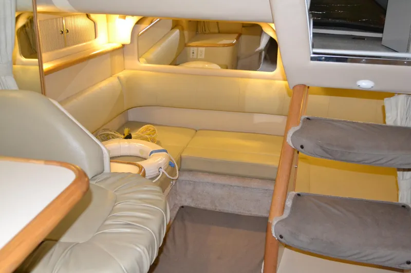 Slide: The Image of Interior of 1998 Sea Ray 330 Sundancer yacht, featuring cozy seating and elegant lighting. - 12