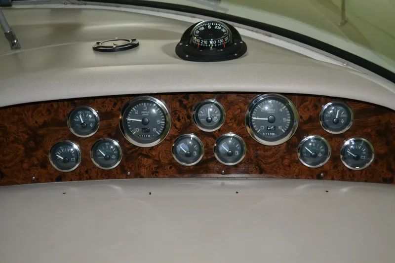 Slide: The Image of Dashboard of a 1998 Sea Ray 330 Sundancer with gauges and compass. - 4