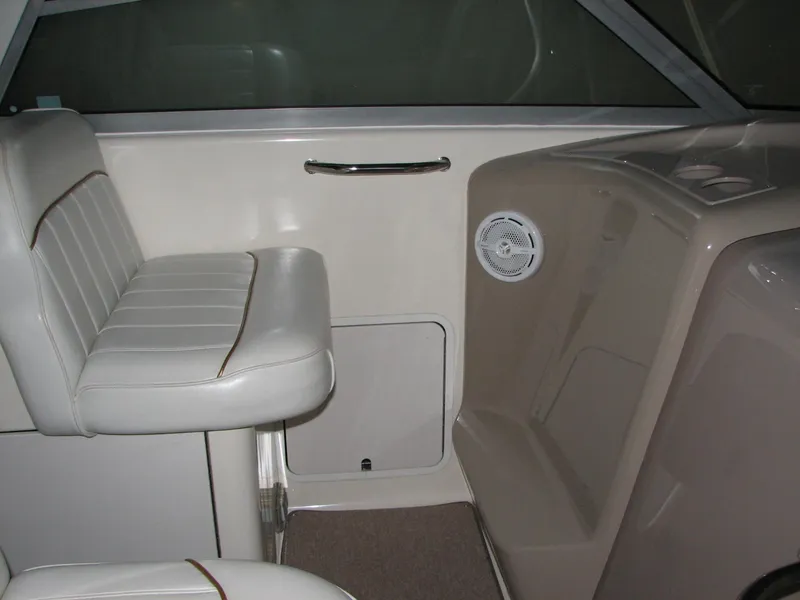 Slide: The Image of 1998 Sea Ray 330 Sundancer interior with white seating and speaker. - 6