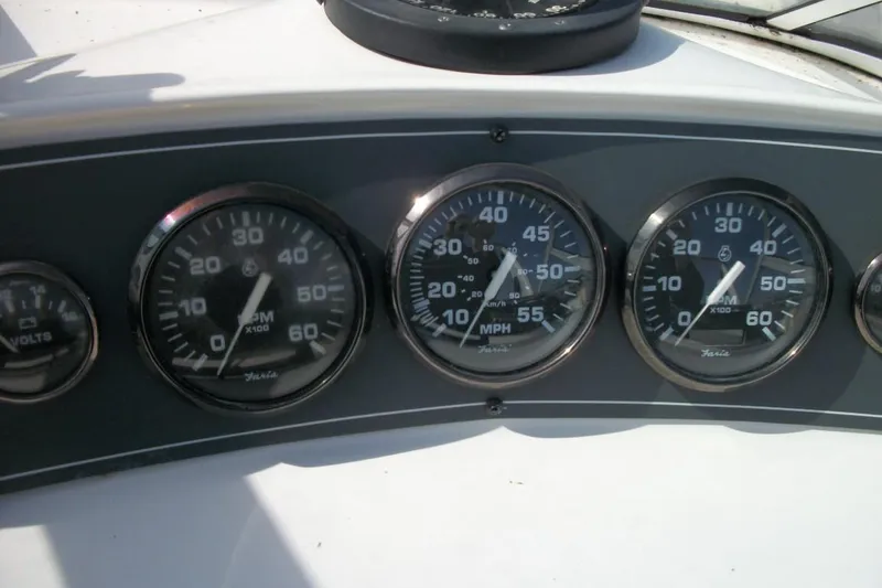Slide: The Image of Instrument panel of a 2001 Thompson 3400 Santa Cruz boat, featuring gauges and dials. - 10