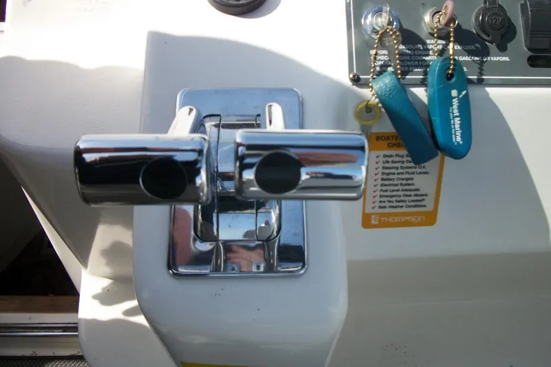 Slide: The Image of Throttle controls and keys on a 2001 Thompson 3400 Santa Cruz boat dashboard. - 13