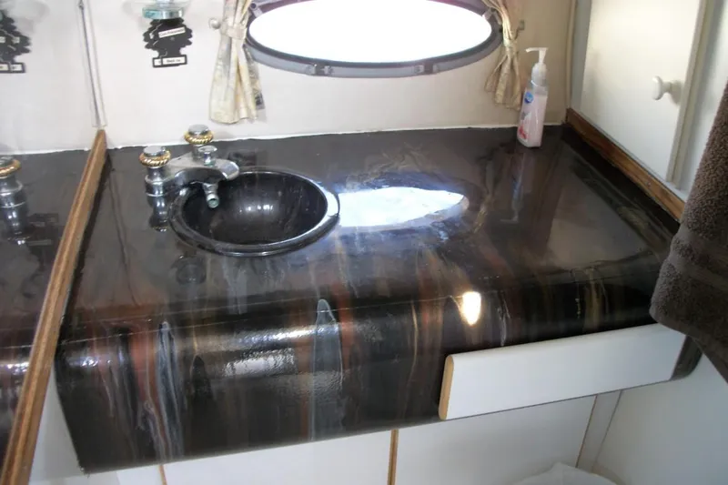 Slide: The Image of Bathroom sink with dark marble countertop in 2001 Thompson 3400 Santa Cruz RV. - 4