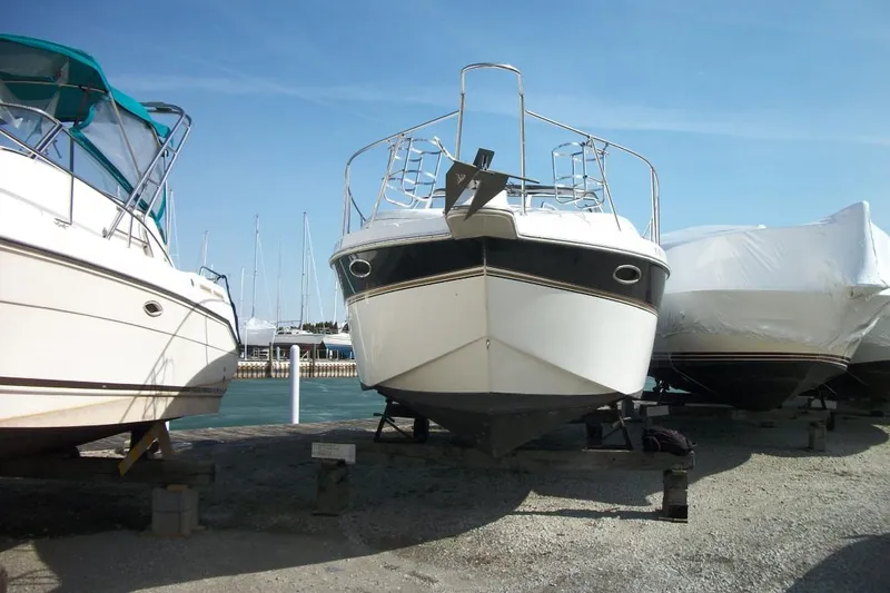 Slide: The Image of 2001 Thompson 3400 Santa Cruz boat on dry dock, surrounded by other boats. - 7