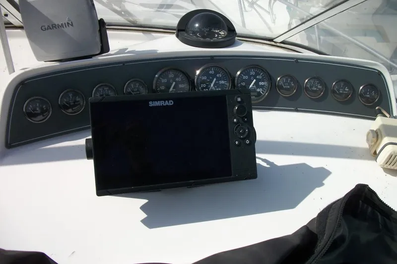 Slide: The Image of Boat dashboard with Simrad and Garmin devices, Thompson 3400 Santa Cruz, 2001 model. - 9